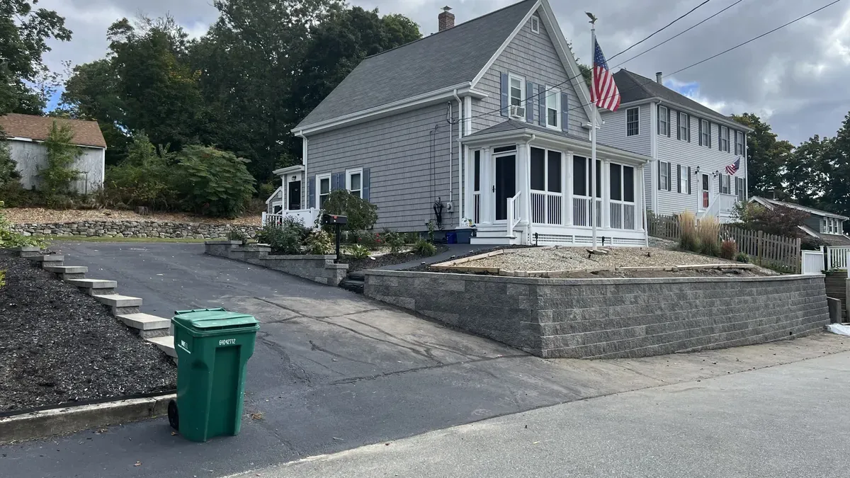Block retaining wall along a residential street corner in Massachusetts